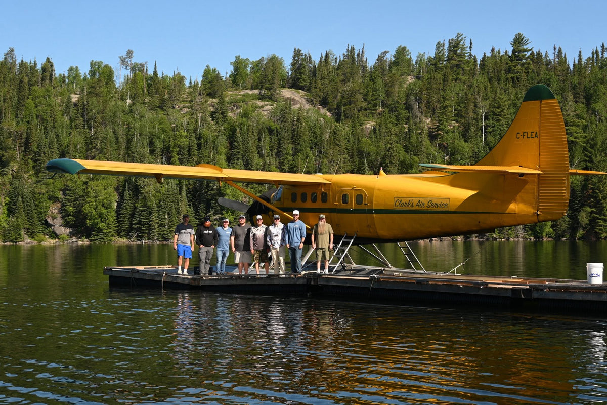 The Lake Effect crew on a dock in front of a float plane