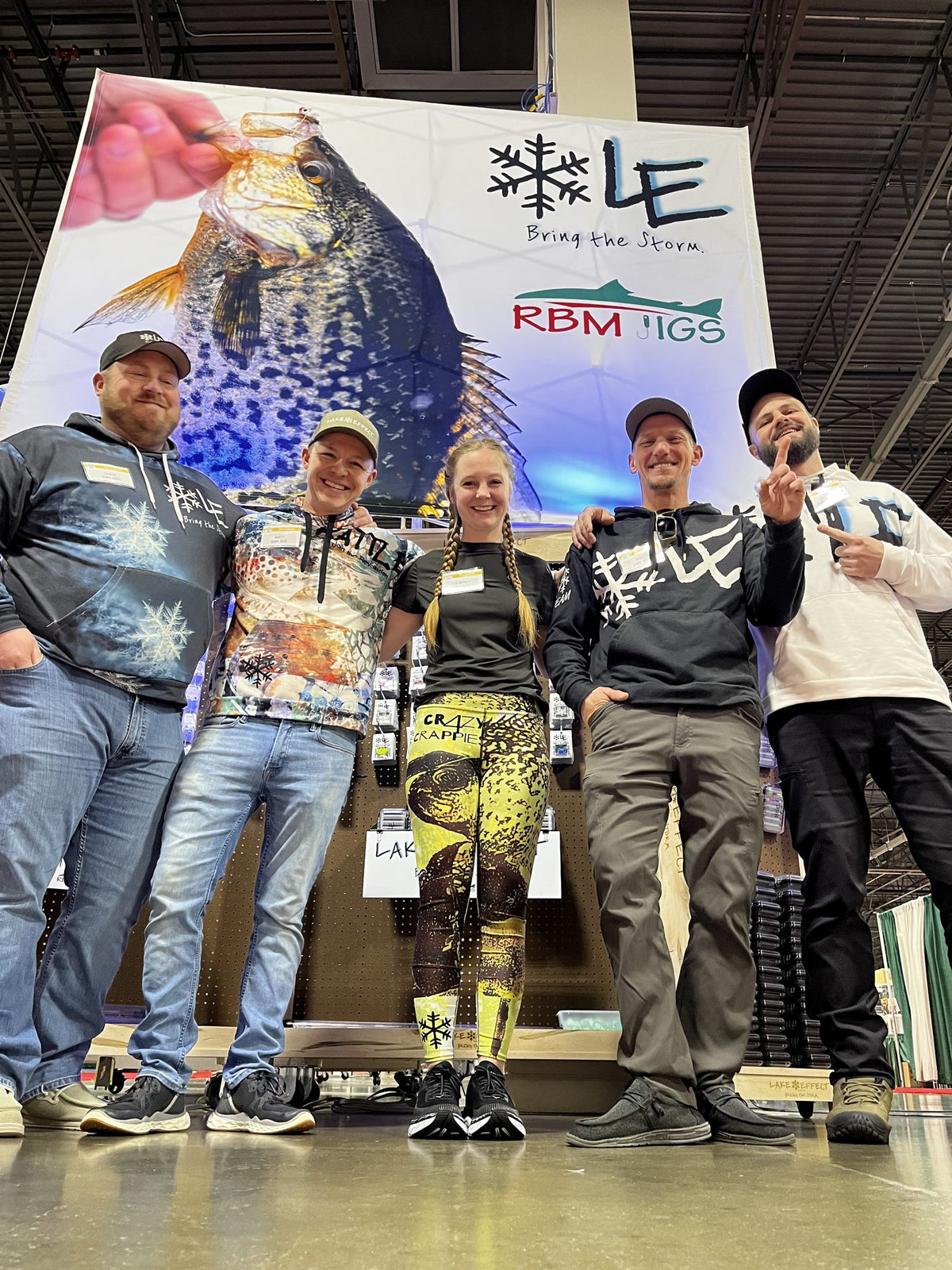 The Lake Effect team in front of the booth banner